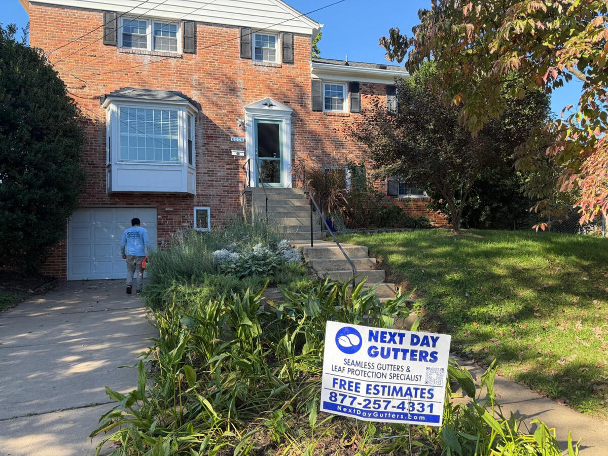 6-inch white seamless aluminum K-style gutters installed on a brick home in Bethesda, MD.